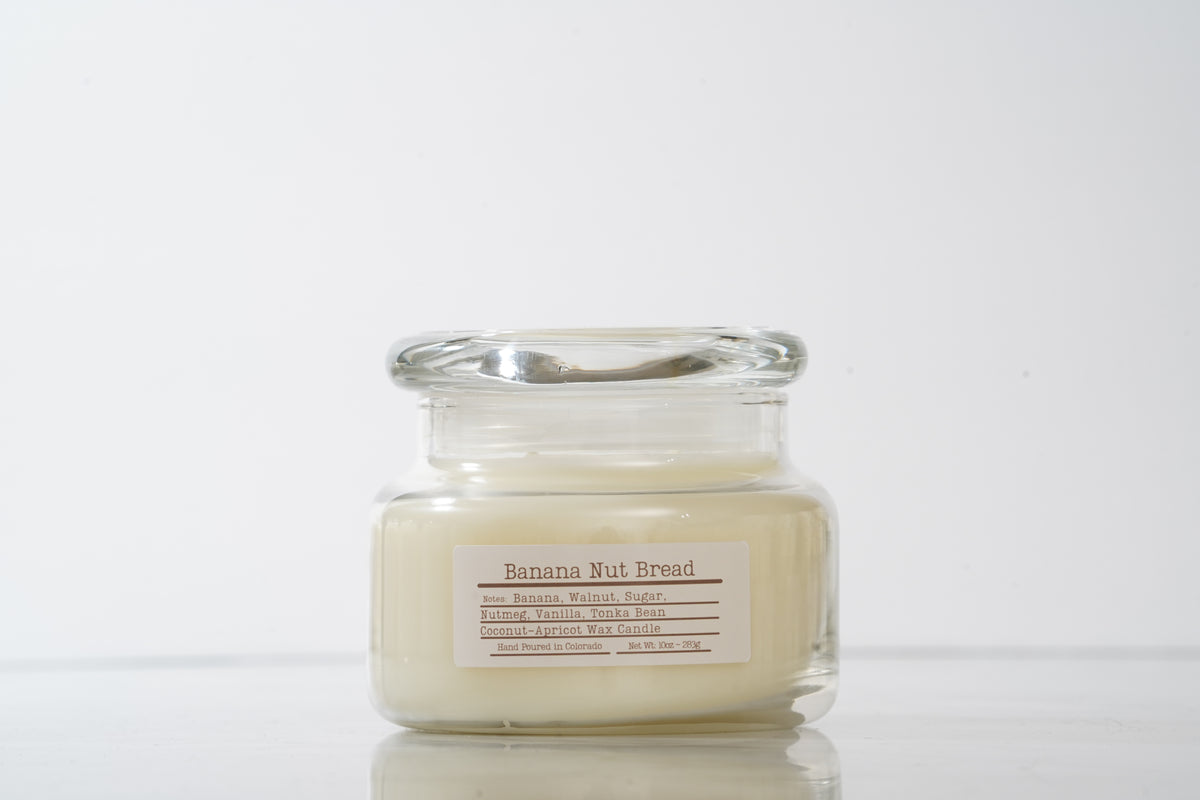 Glass jar scented candle labeled Banana Nut Bread